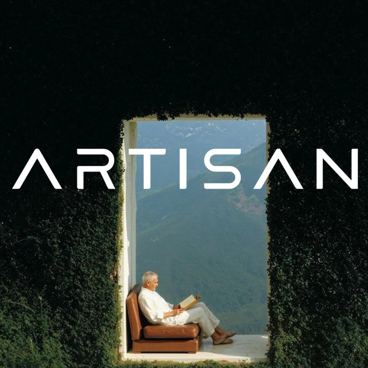 ARTISAN text above a man reading in an ivy-framed opening overlooking mountains.