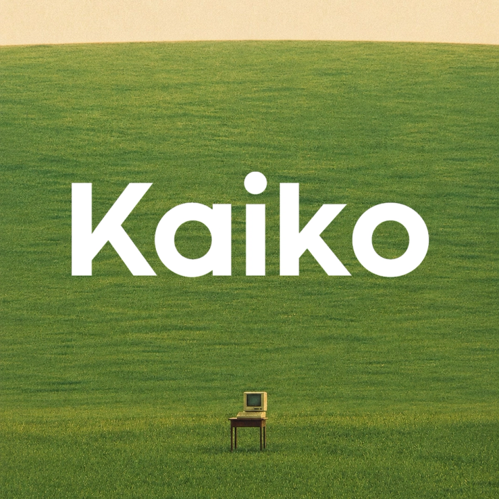 White "Kaiko" text over a green field with a vintage computer monitor on a small table.