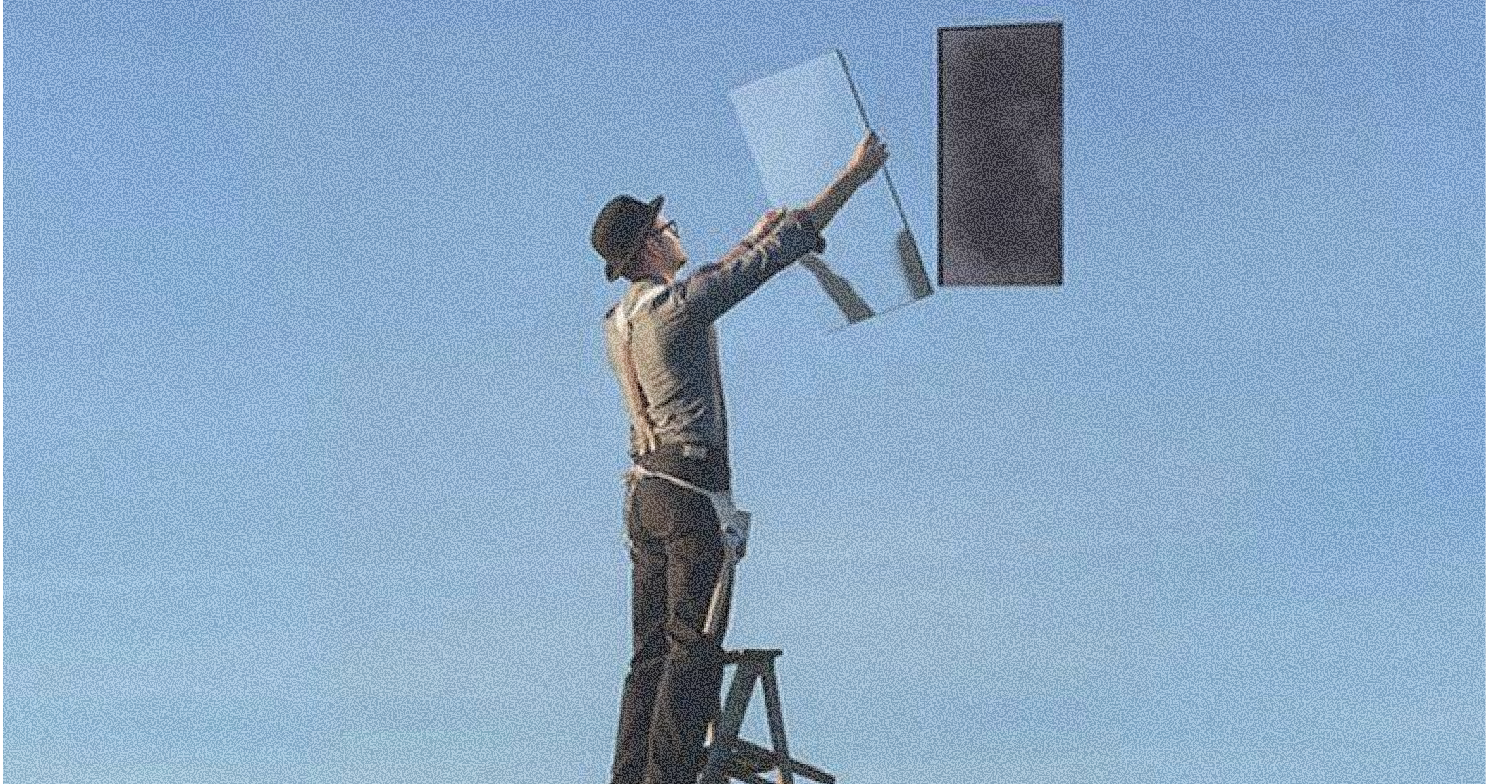 Man on a ladder holding a mirror, with a dark rectangle floating in a blue sky.
