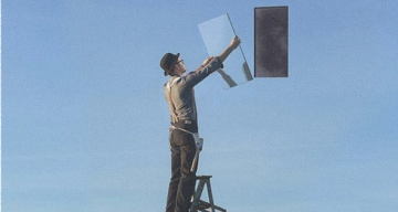 Man on a ladder holding a mirror, with a dark rectangle floating in a blue sky.