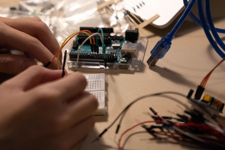 child hands circuit board wiring