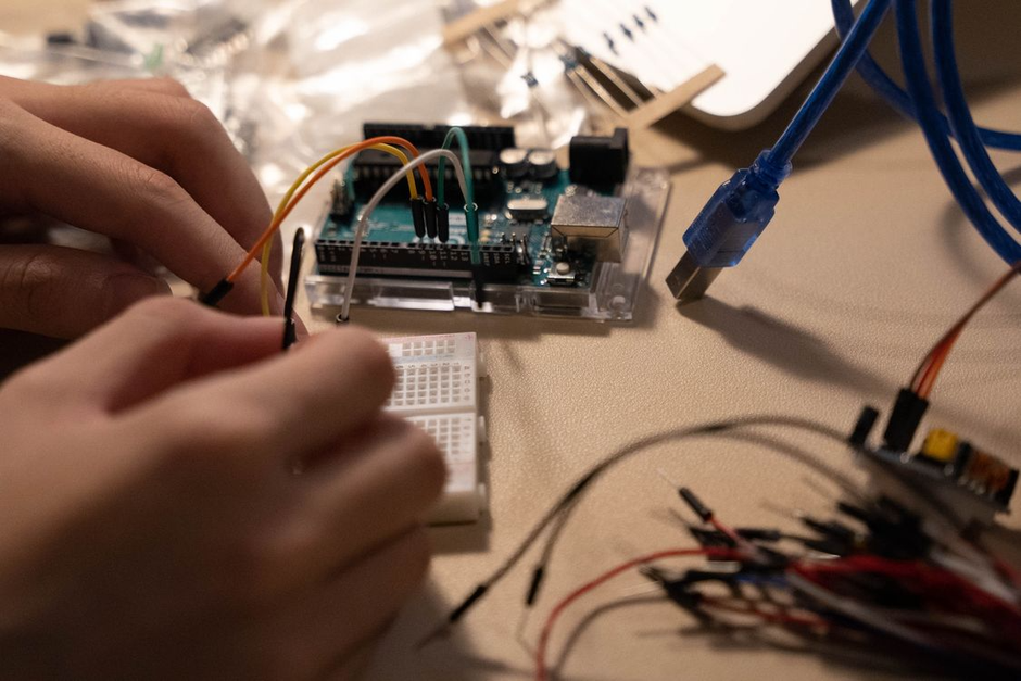 child hands circuit board wiring