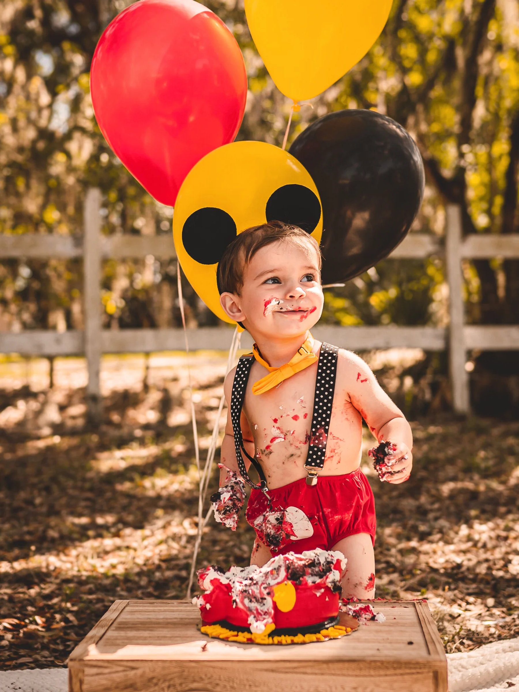 A child celebrating his birthday with balloons