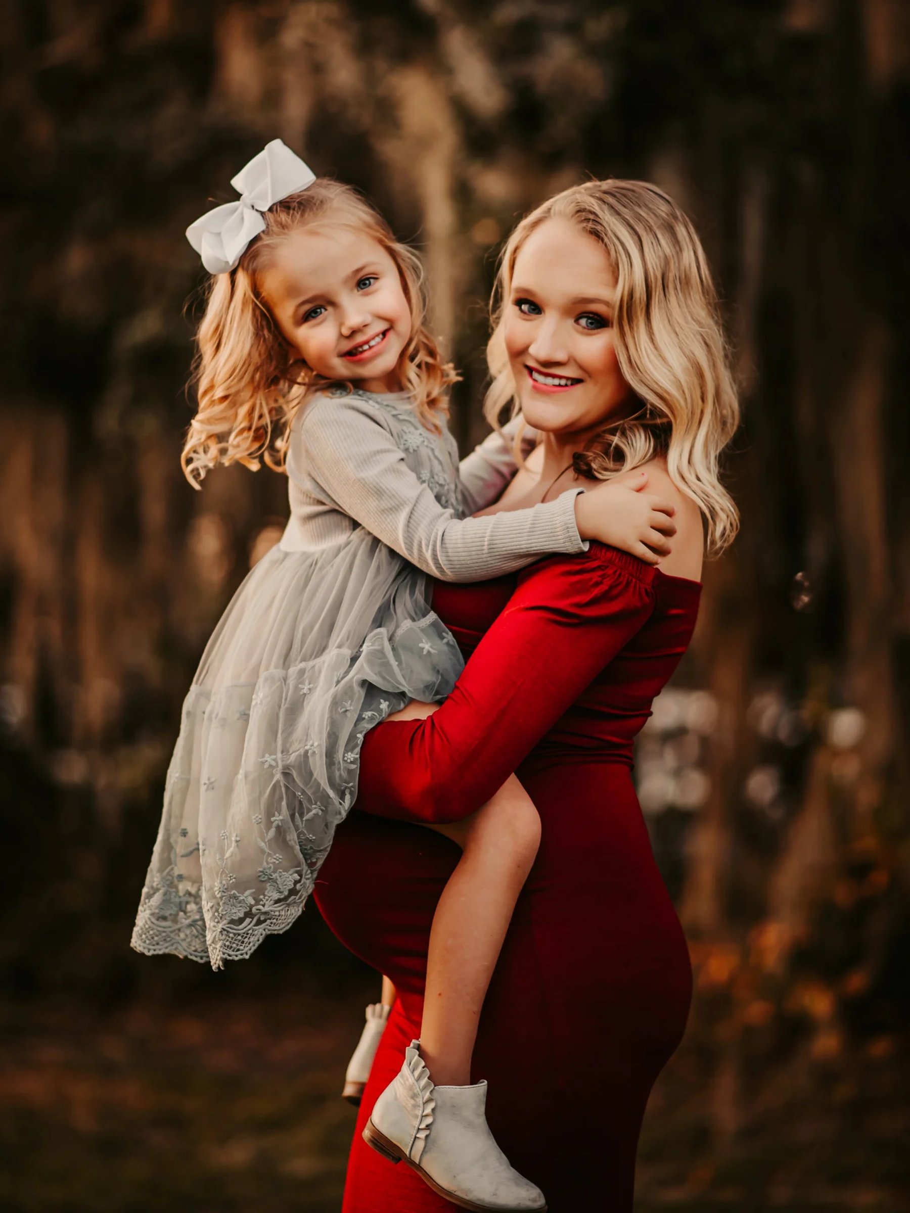 Mother and daughter laughing together outdoors