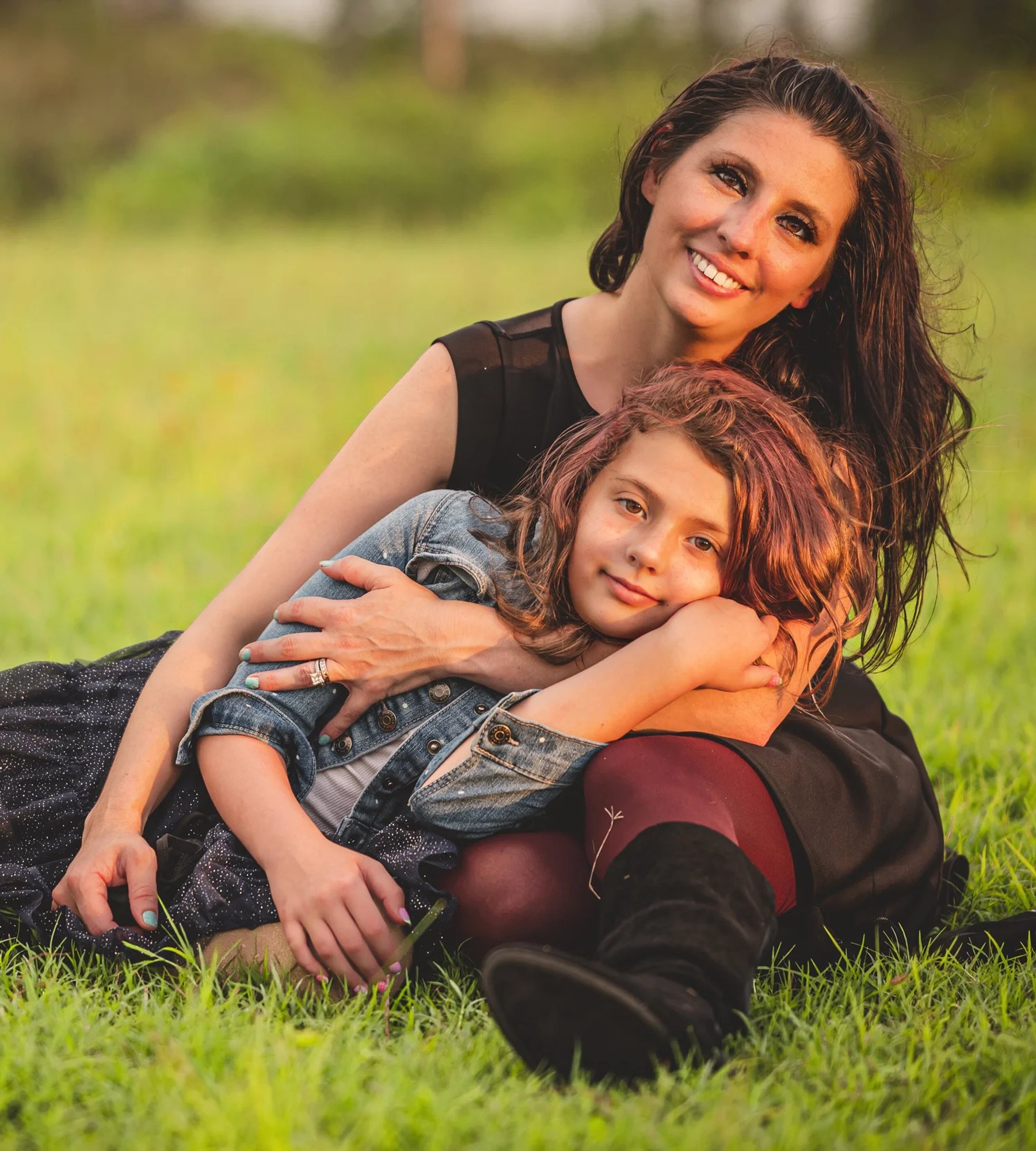 Mother and daughter relaxing together in the grass