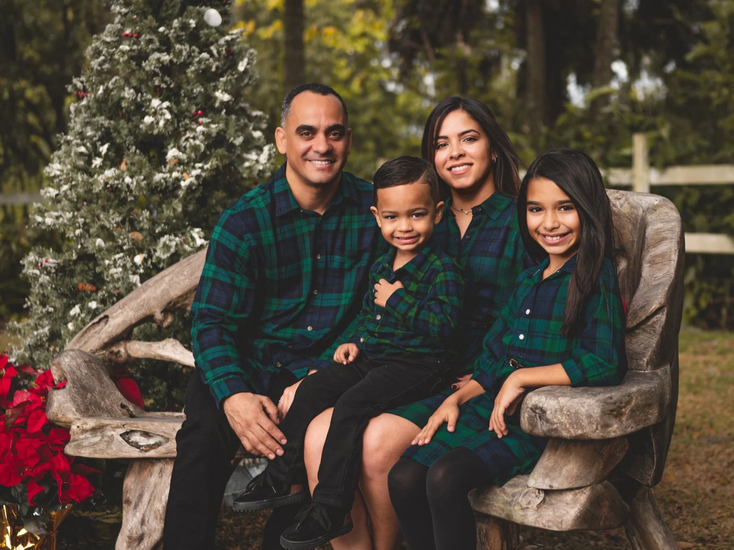 A family of four sitting together for their holiday portraits