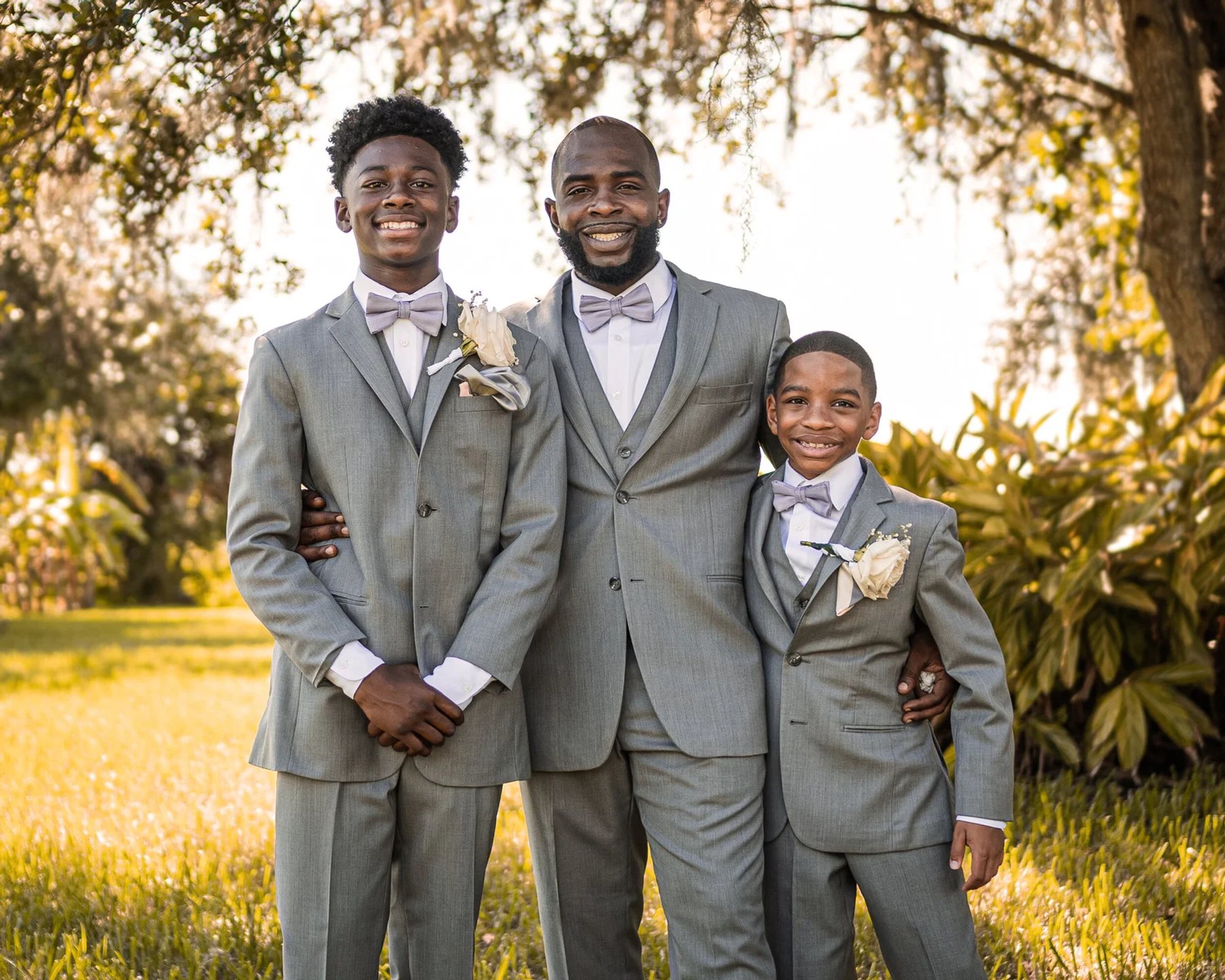 A father and his two sons in coordinating suits