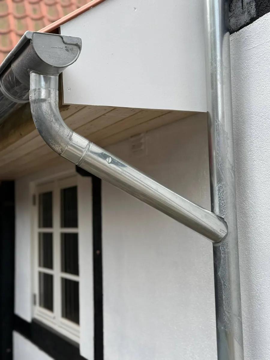 Zinktagrender i titanzink monteret på dansk villa - naturlig patina beskytter overfladen mod korrosion og fugt i mange år