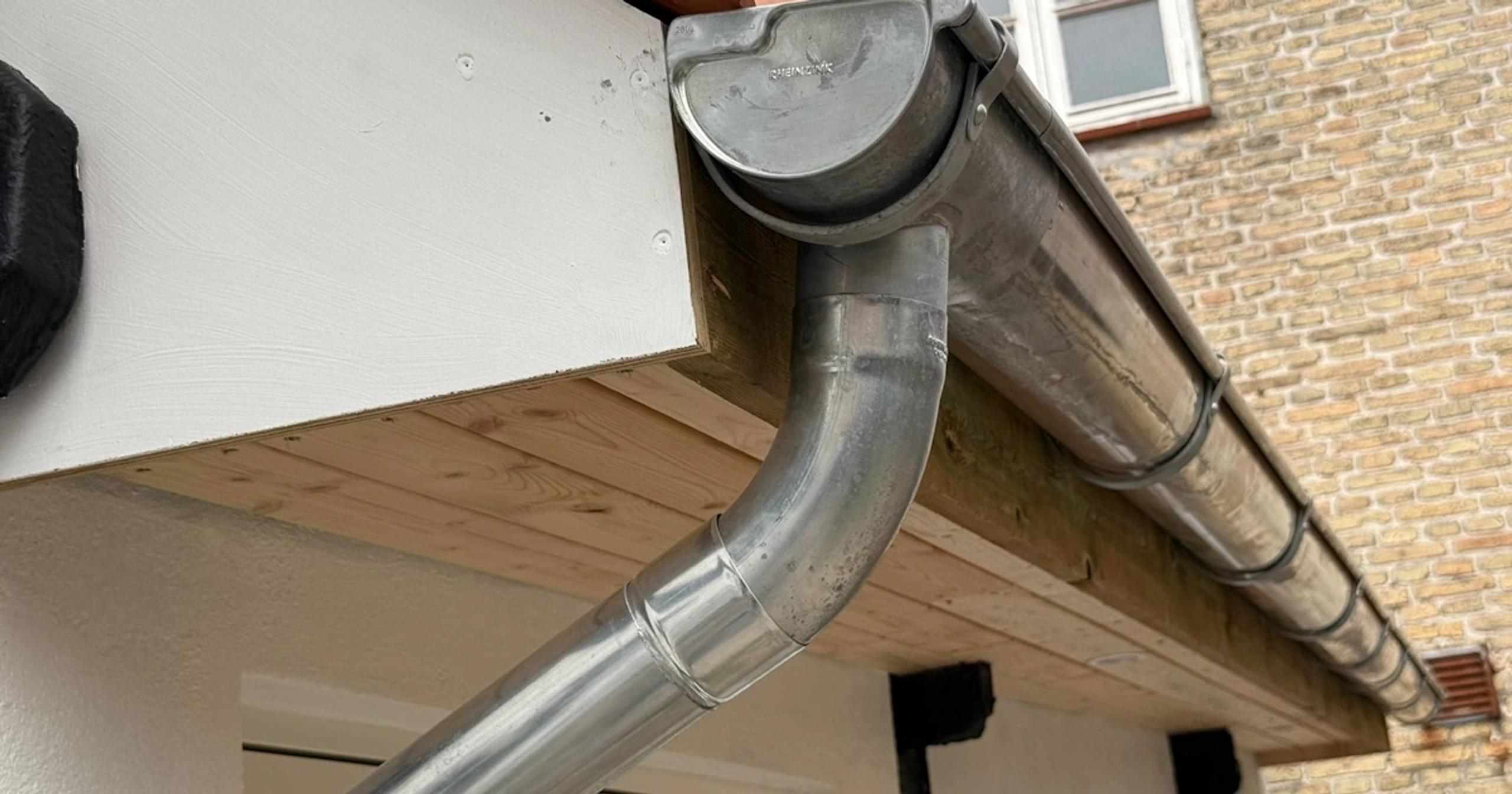 Nye zinktagrender monteret på parcelhus i København - titanzink med naturlig patina beskytter facade og sokkel mod fugt