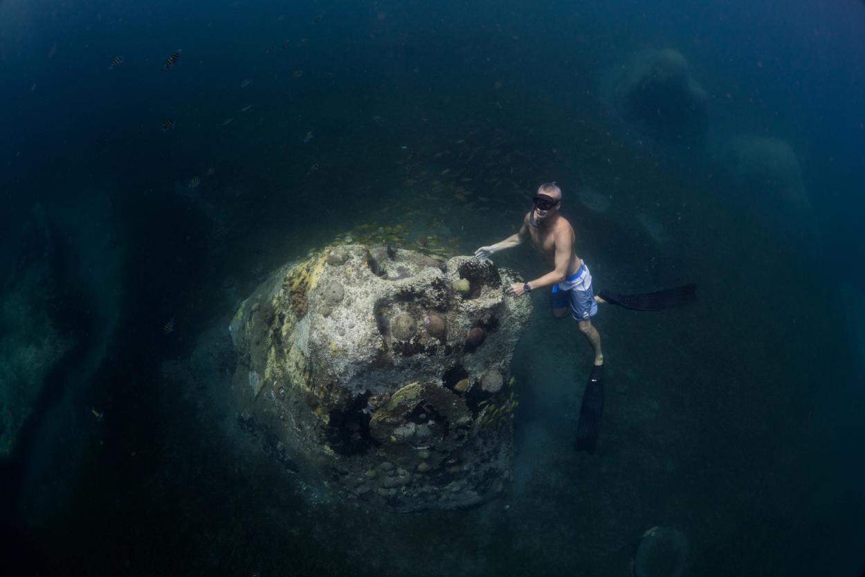 Freediver with mermaid sculpture