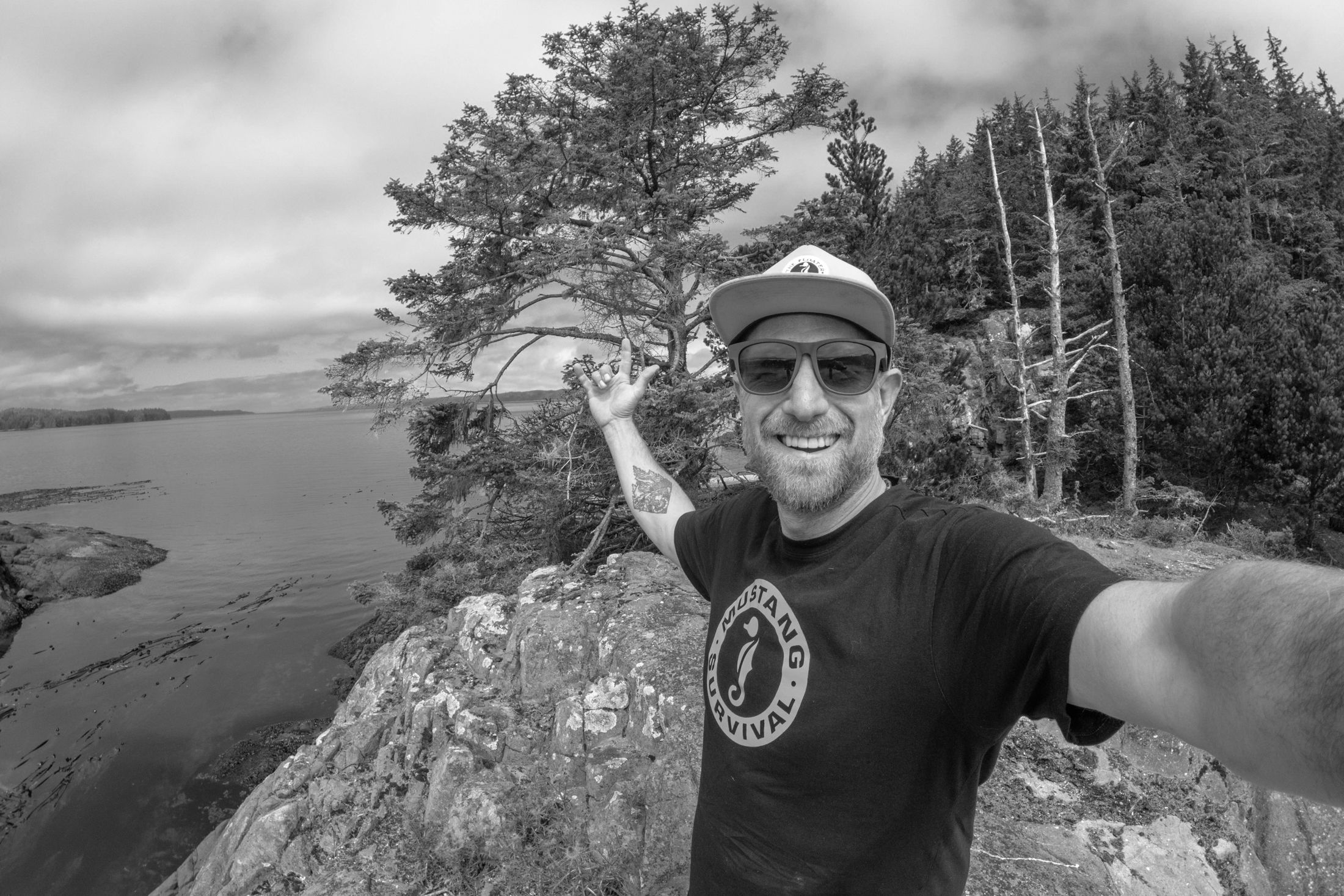 Self portrait of a man wearing sunglasses and a hat outdoors