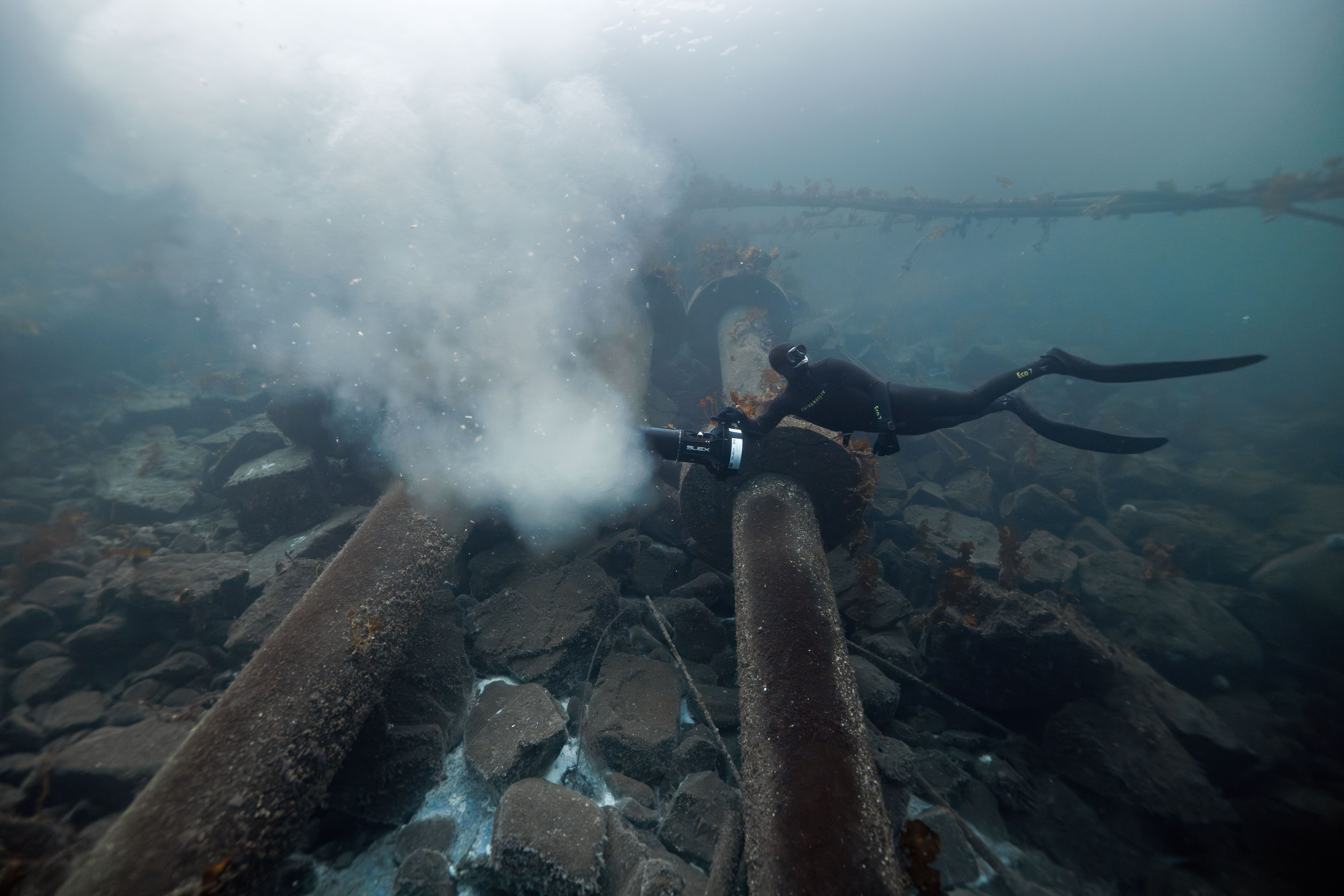 Diver over polluting underwater  pipes in Norway
