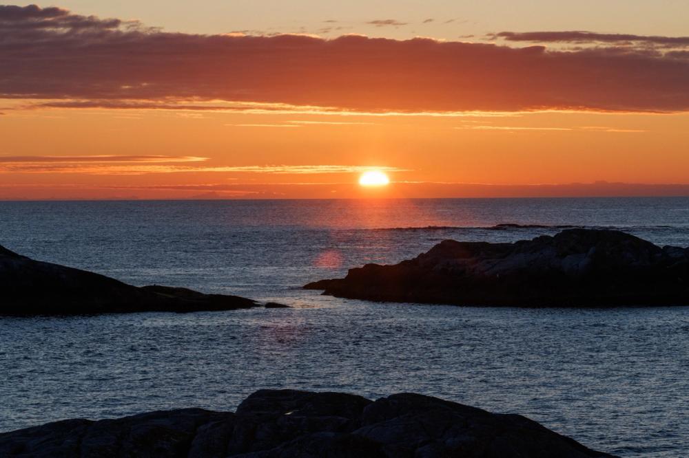 A view of the rocks surrounding the island of Grip, against the sunset.
