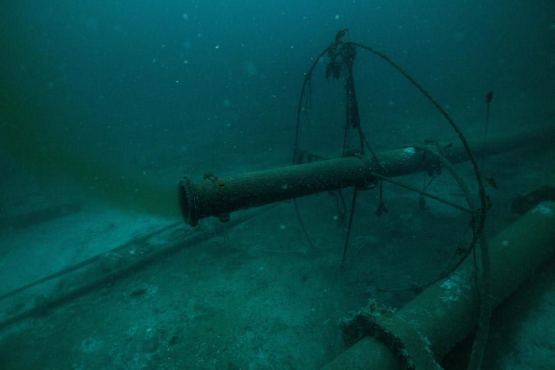 A pipe on the seabed spewing pollutants