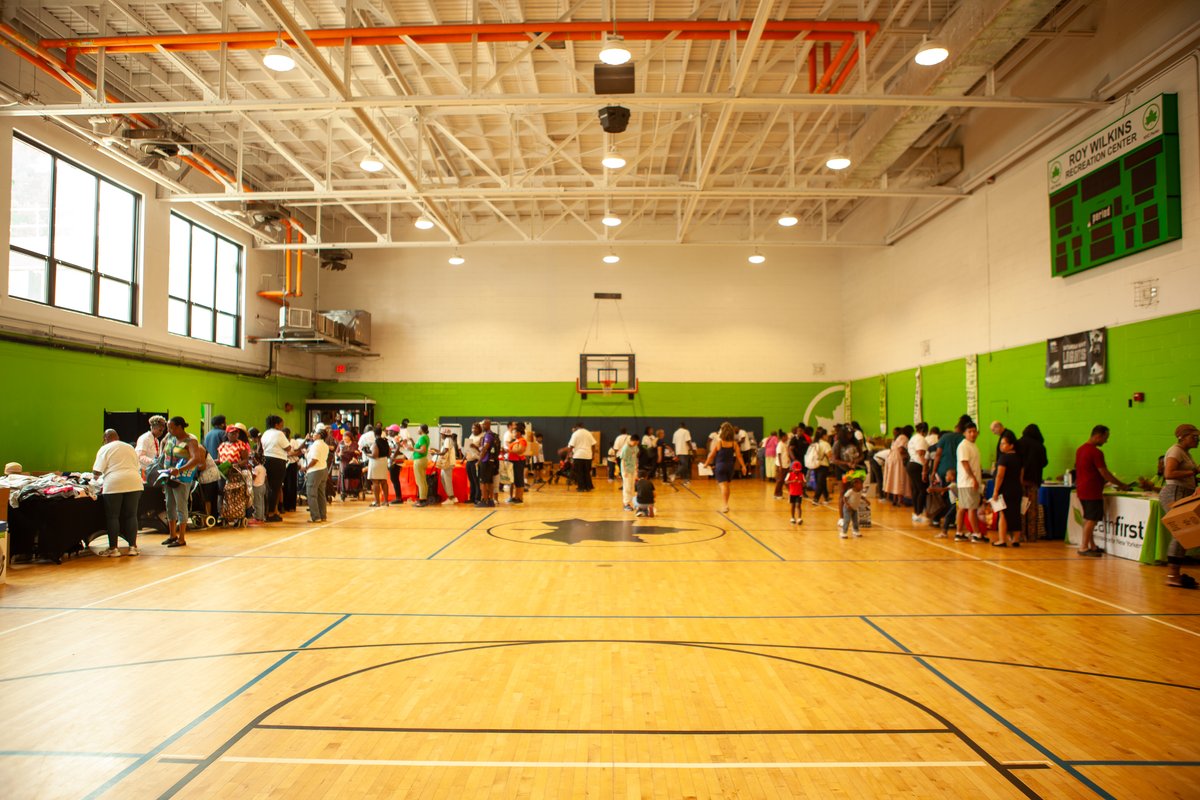 Families and neighbors gathered inside the Roy Wilkins Recreation Center gymnasium during the Queens Community Closets Launch & Resource Fair
