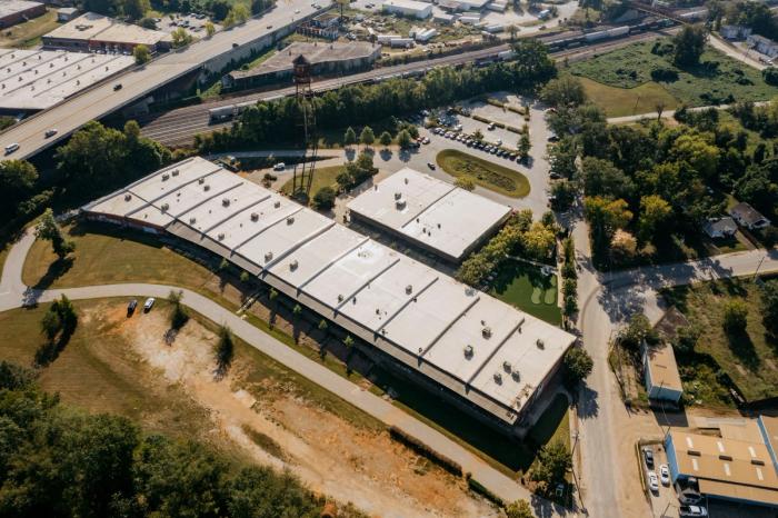 Aerial view of commercial low-slope warehouse roofs suited to modified bitumen systems