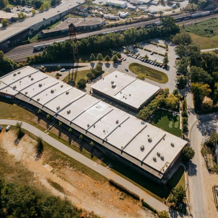 Aerial view of commercial low-slope warehouse roofs suited to modified bitumen systems