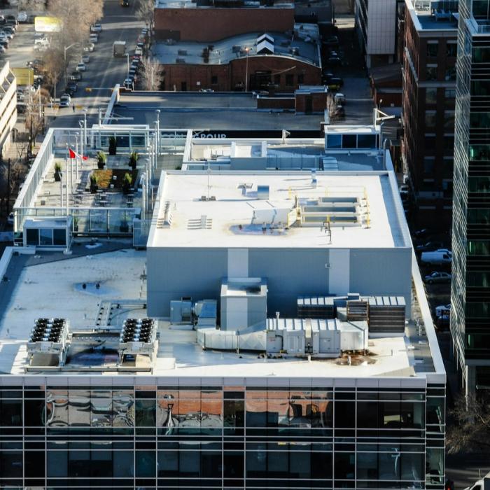 White reflective commercial low-slope rooftop similar to a silicone coating system