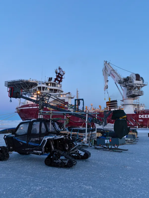 Specialized filming equipment and Arctic-adapted vehicles in use near the DEEPOCEAN research vessel in Svalbard. PolarX enables high-impact shoots on Arctic sea ice, combining cinematic visuals with robust logistics, even in challenging maritime settings.