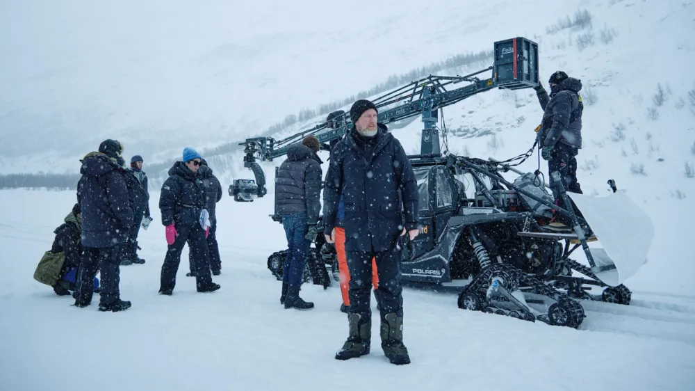 On set in Bøverdalen, director Roar Uthaug and the Norwegian crew work through deep snow and shifting mountain weather to capture Troll 2’s defining scenes. Courtesy of Netflix © 2024