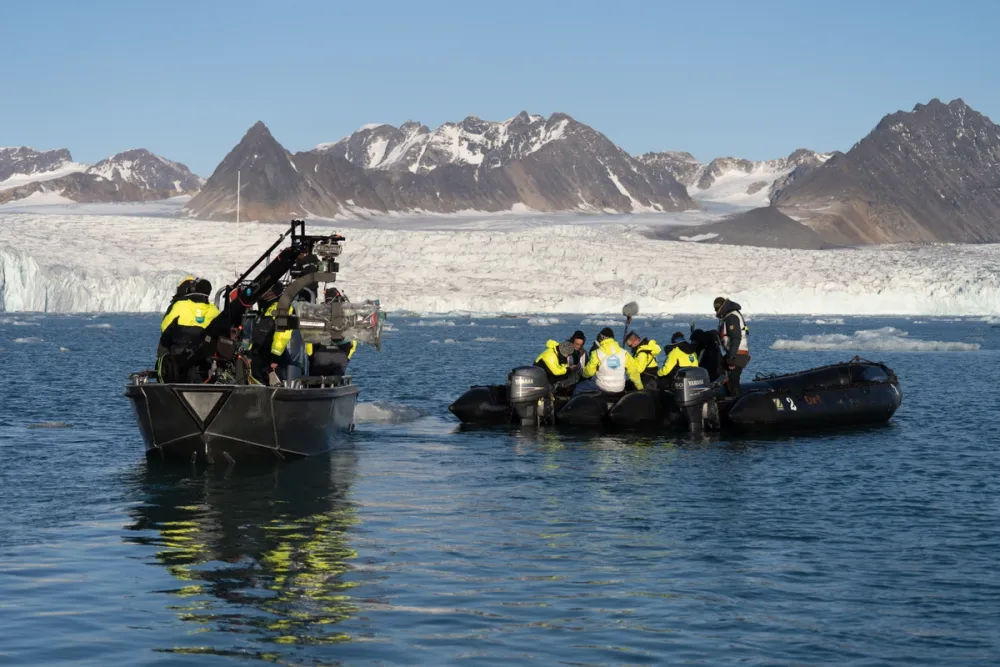Film crews from PolarX operate on Arctic waters in Svalbard with stabilized camera rigs and crew support boats near a stunning glacier front. These mobile marine units enable cinematic filming in fragile polar ecosystems, combining precision, safety, and low-impact logistics.