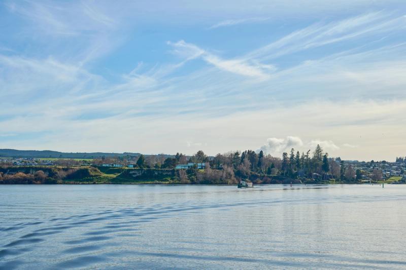 Scenic view across Lake Taupō toward the mountains, where we provide lifestyle build estimates.