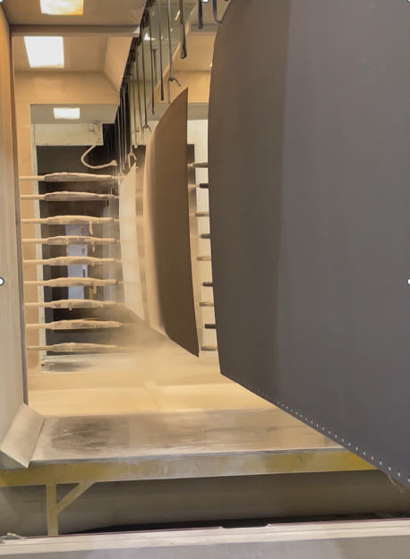  show guard walls or stringers for a custom curved or spiral staircase during the construction process, likely being sealed or prepared for a final finish like plastering or veneer. 