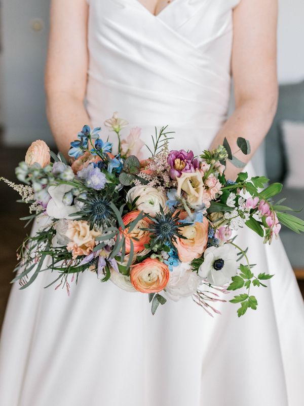Bride poses with bouquet for picture