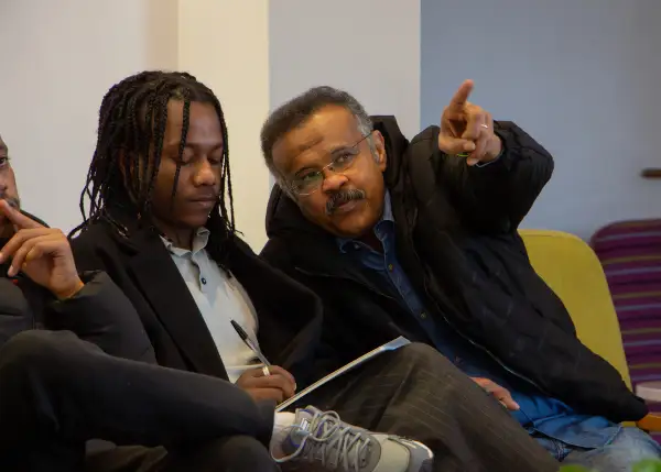 Seeds of Hope Translator, Hamed, walking Hossam through a PowerPoint