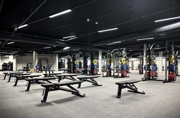 A glimpse of our sports center Kronstad X. It features a fully-equipped gym with weights, dumbbells, and a variety of exercise equipment.