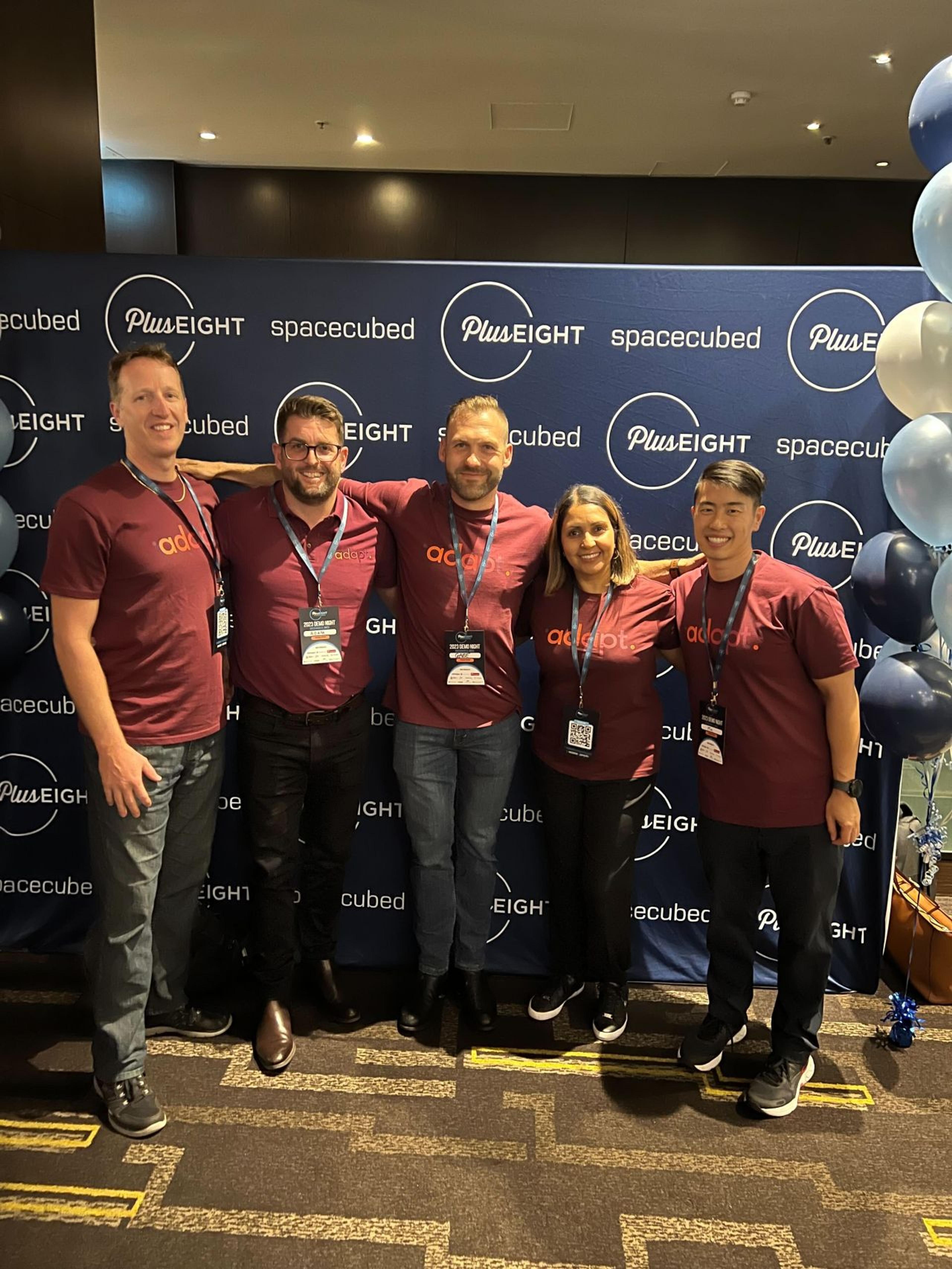 Adapt team members at the Plus Eight event by Spacecubed, posing for a group photo.