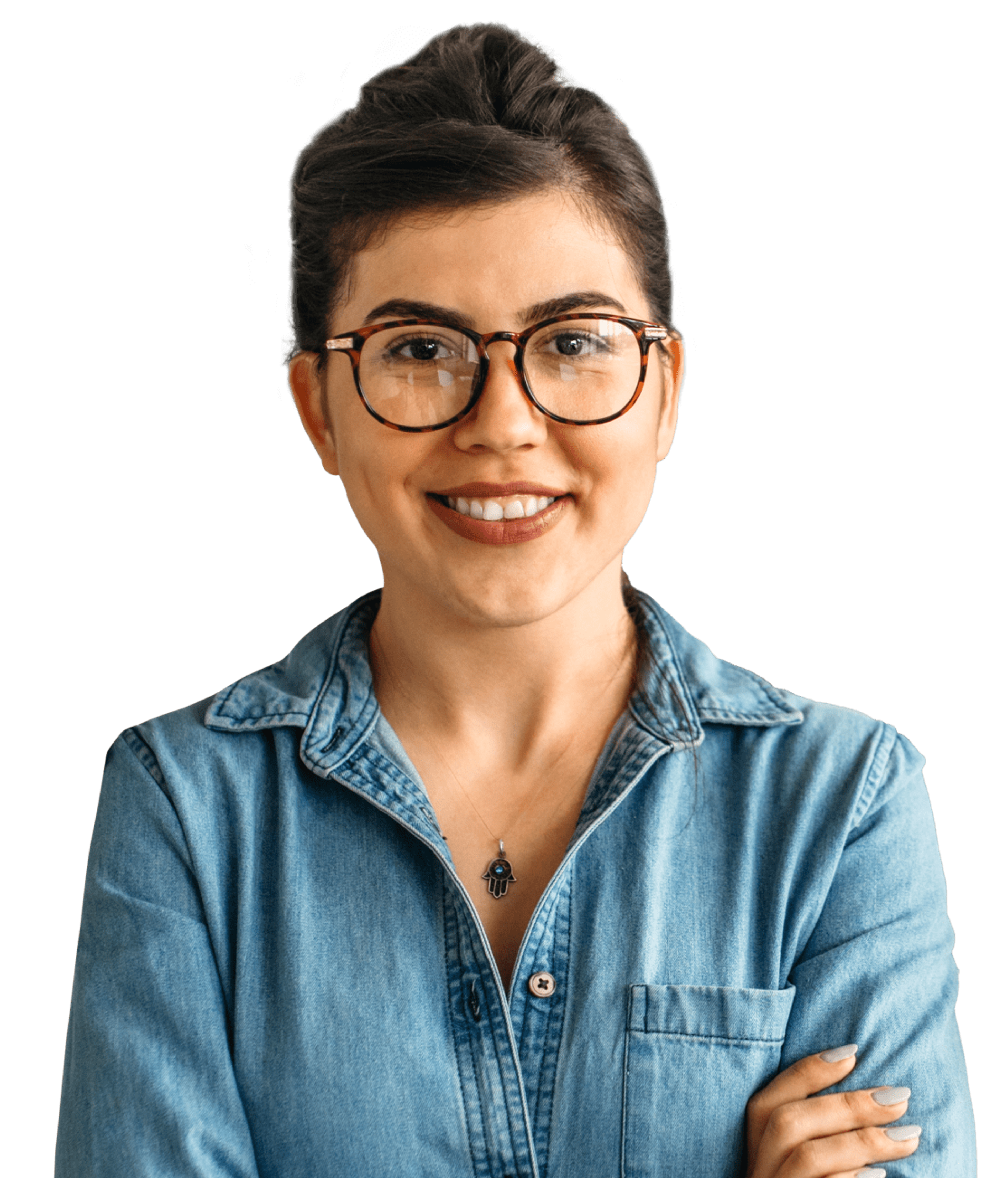 Woman wearing glasses and denim shirt. Arms folded, smiling at camera.