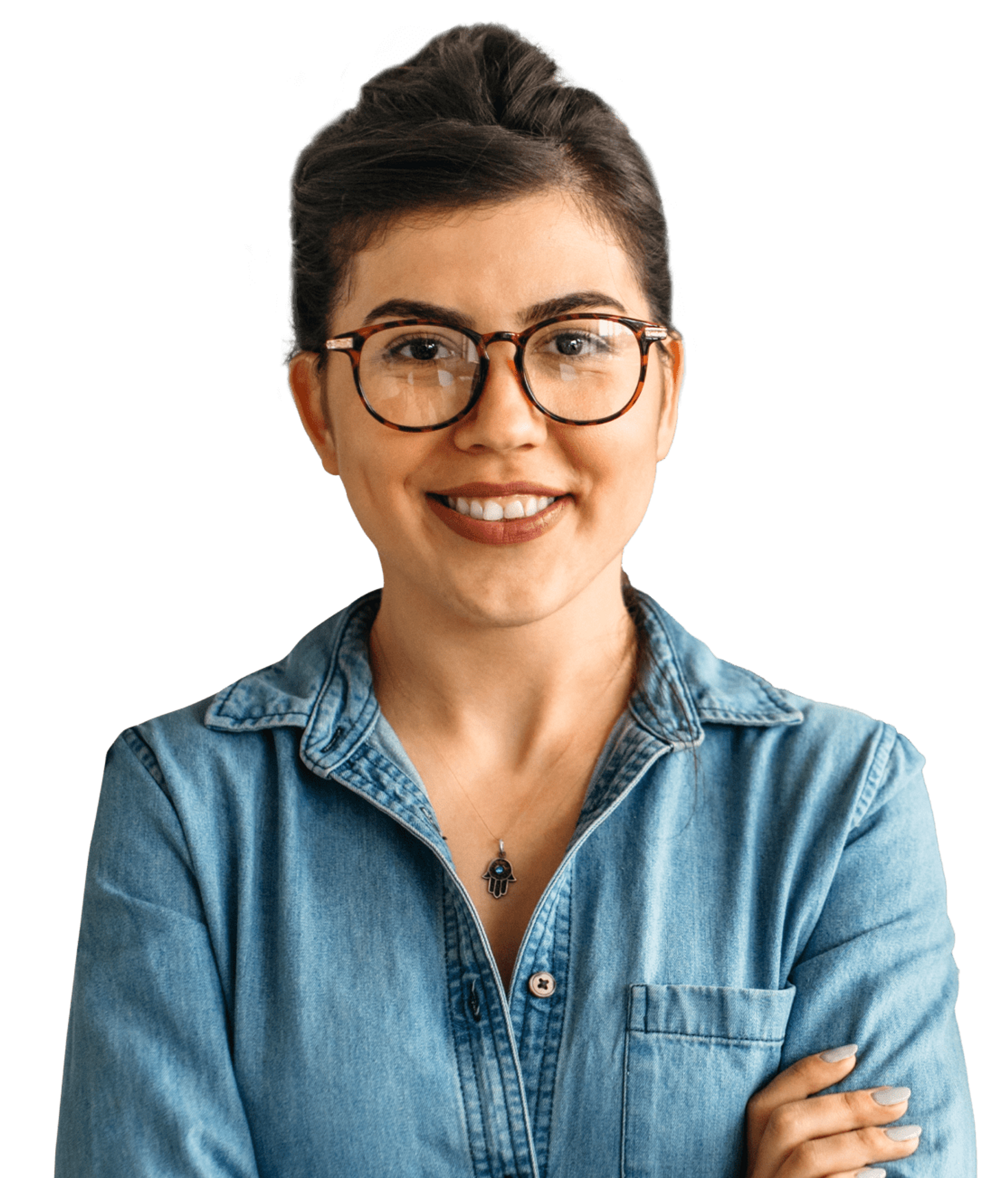 Woman wearing glasses and denim shirt. Arms folded, smiling at camera.
