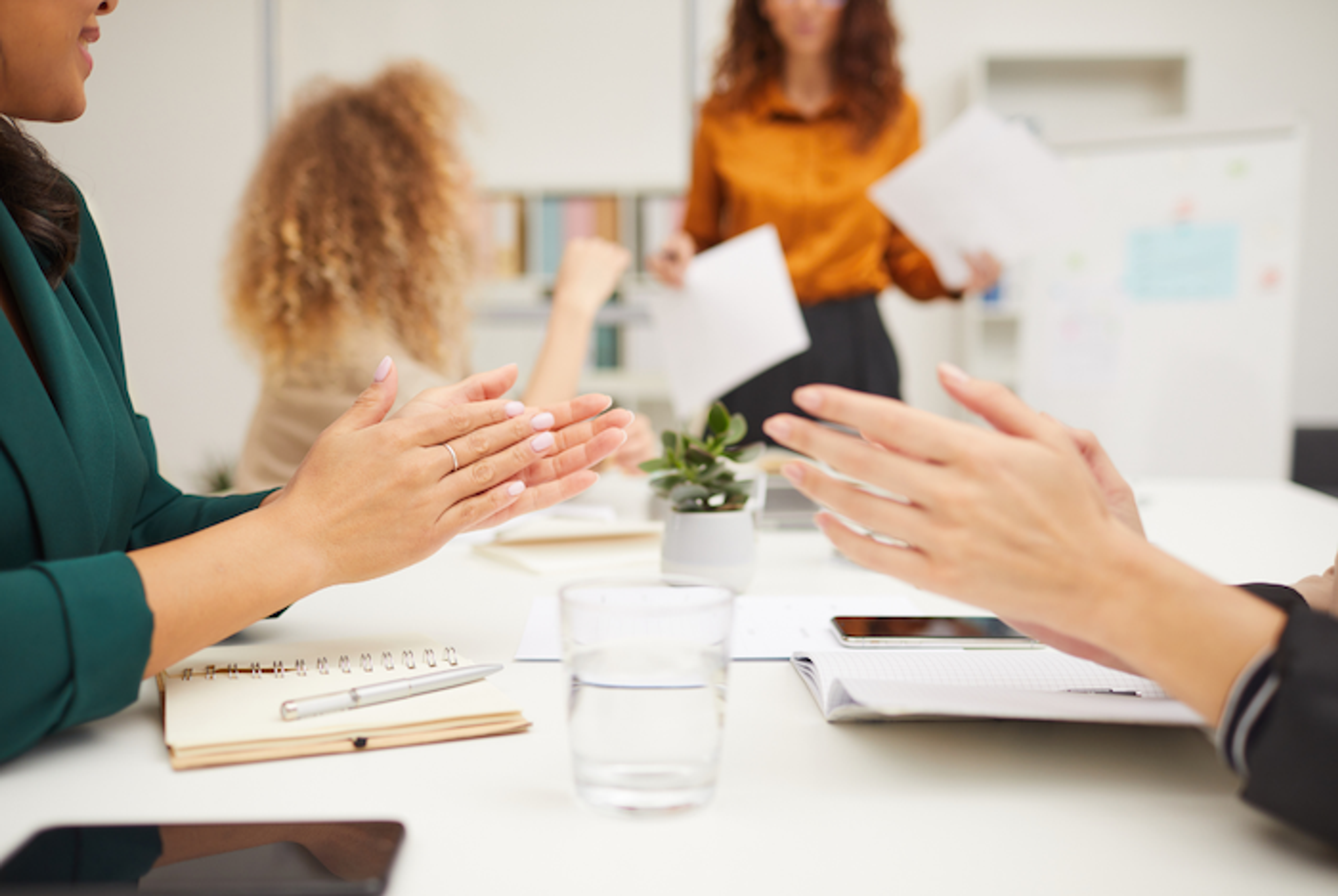A business leader presenting to a team, demonstrating enhanced communication and collaboration through leadership coaching