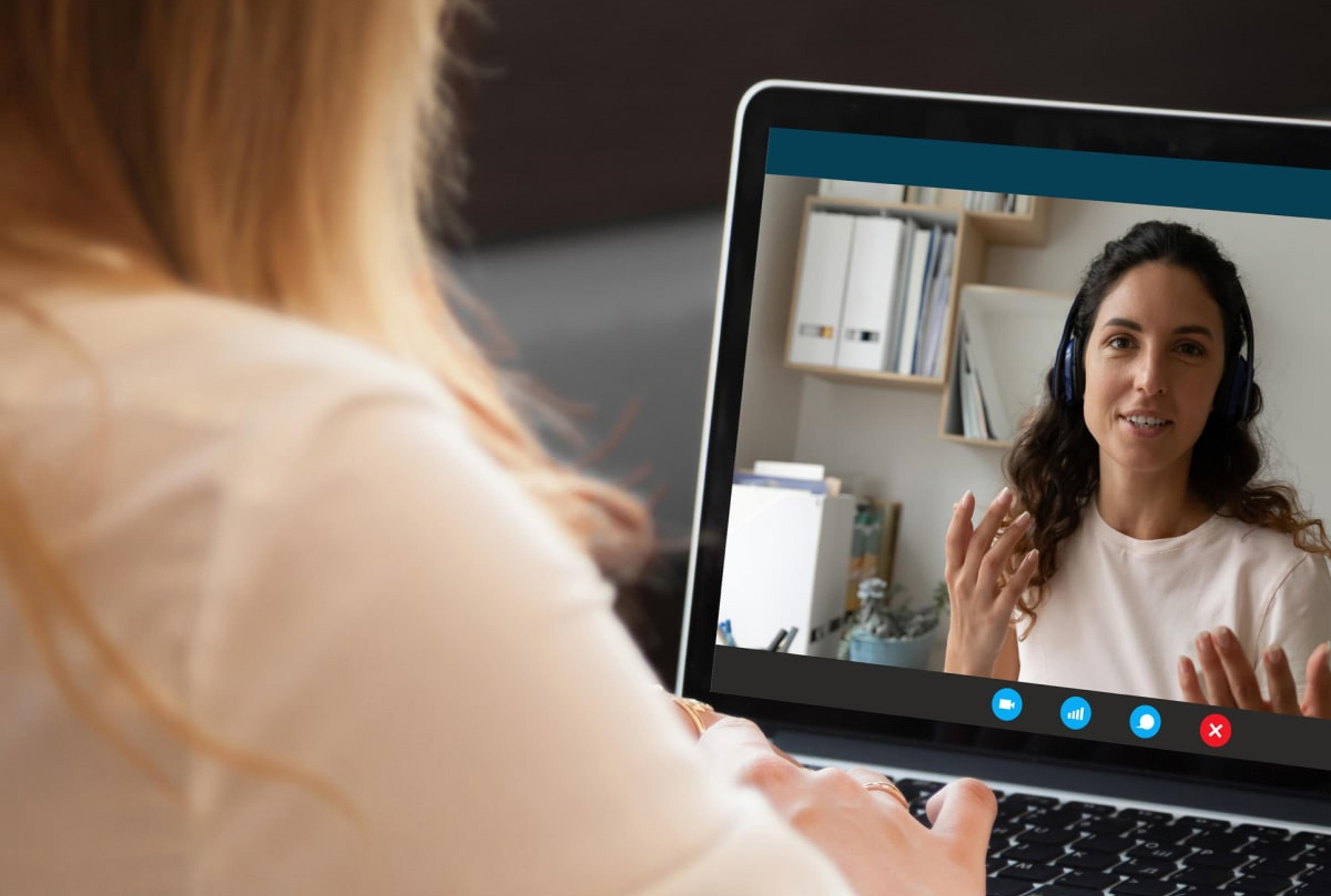 Woman participating in a video call with her coach, highlighting remote coaching support.
