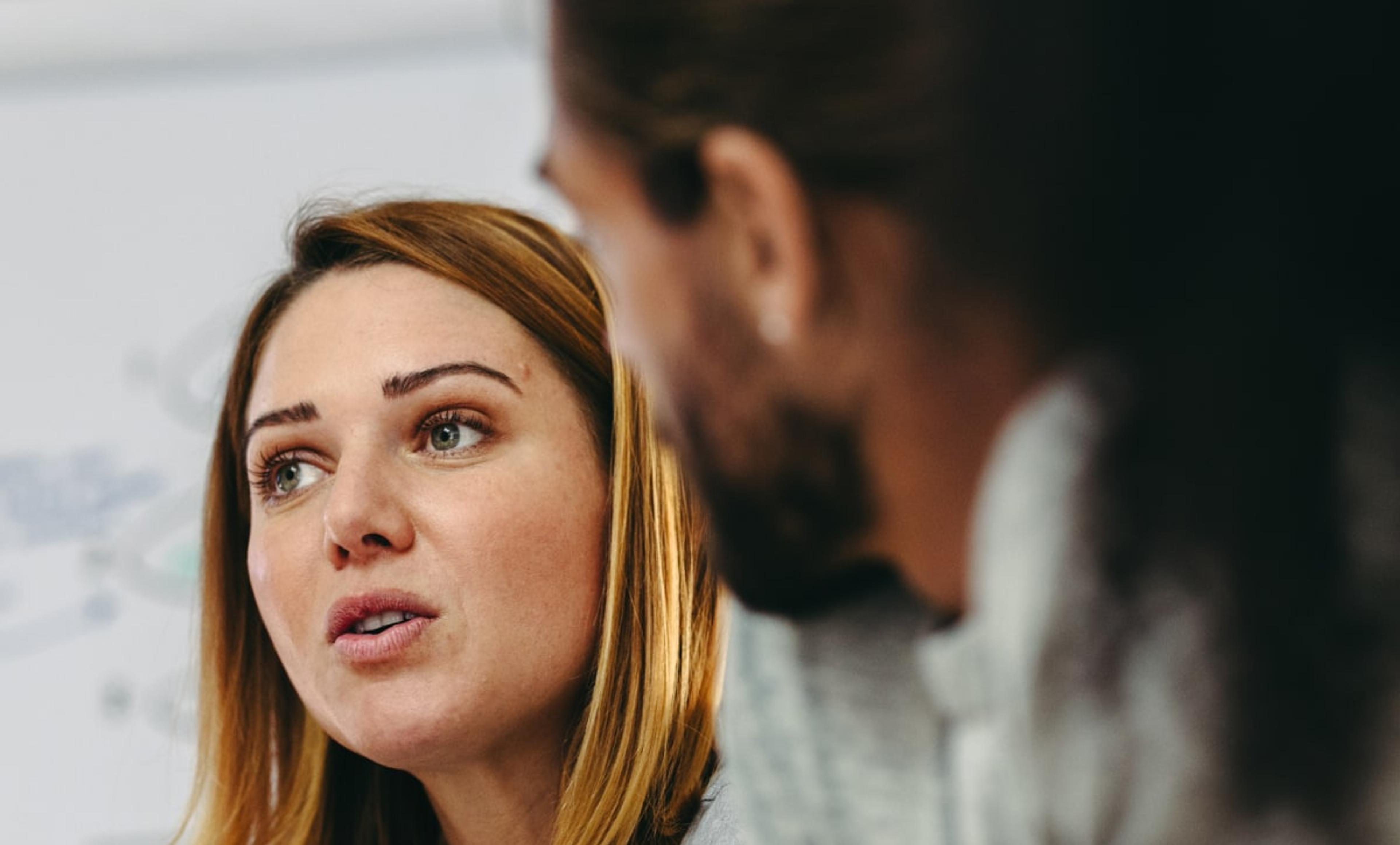 Female business leader engaged in a strategic discussion with a colleague, representing personalized coaching guidance.