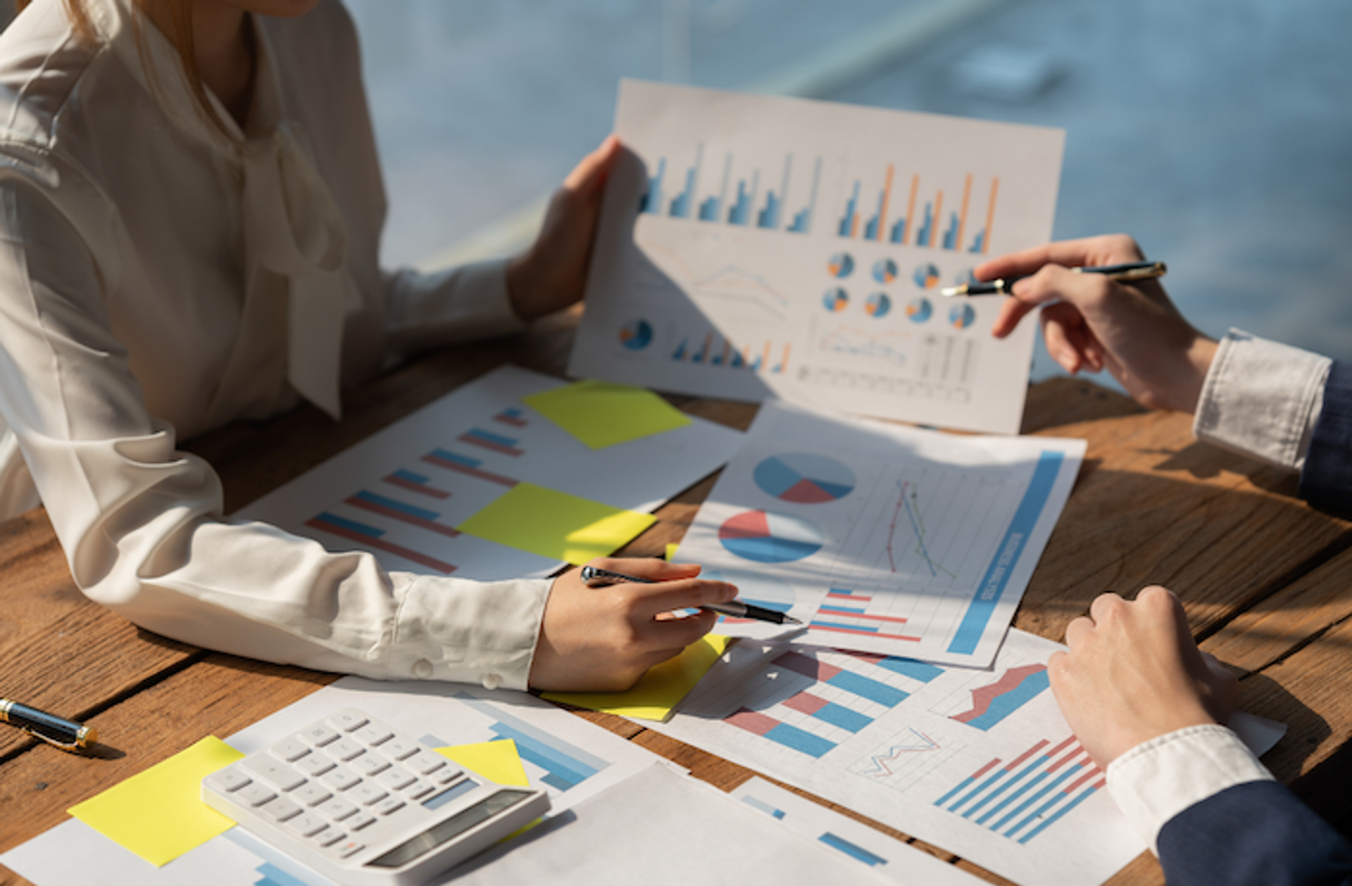 Business professional calculating business valuation using financial reports and strategic analysis