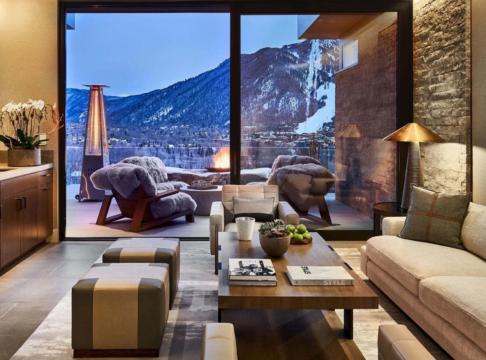 modern living room with balcony looking out at the mountains