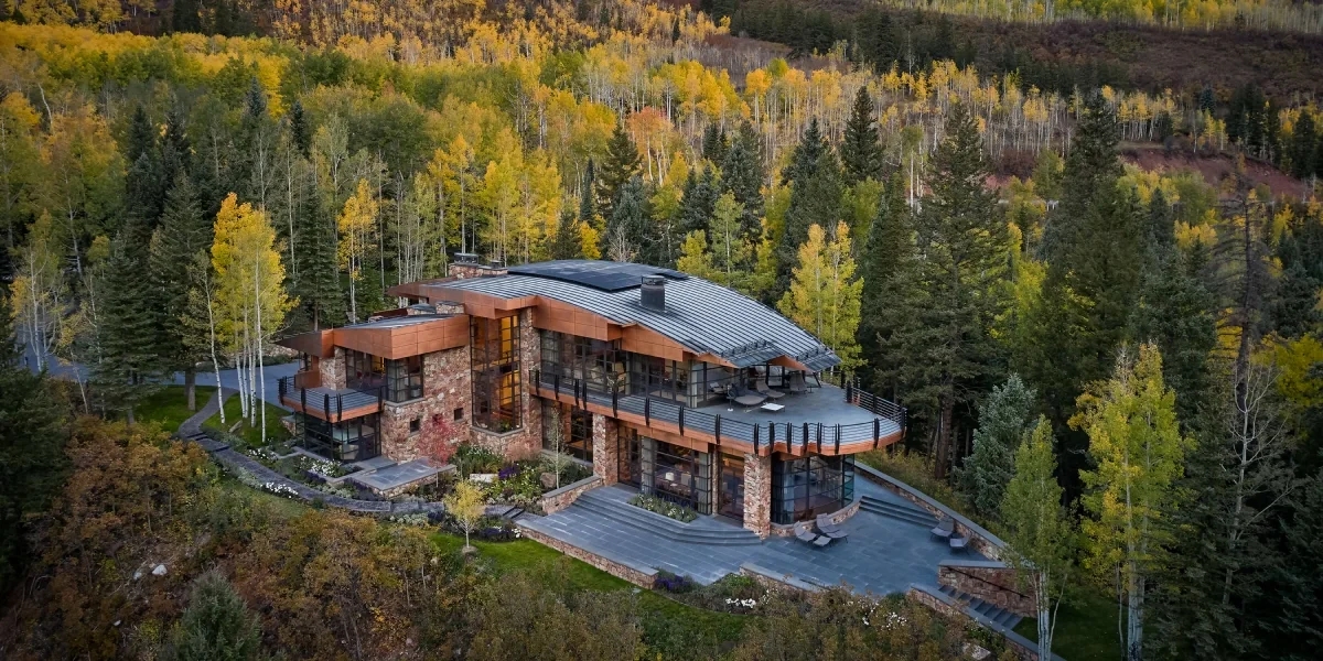 aerial view of a modern mountain home surrounded by trees