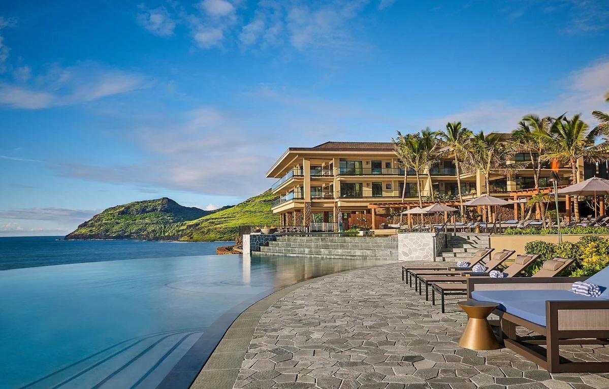 oceanfront resort with pool with mountains in the background