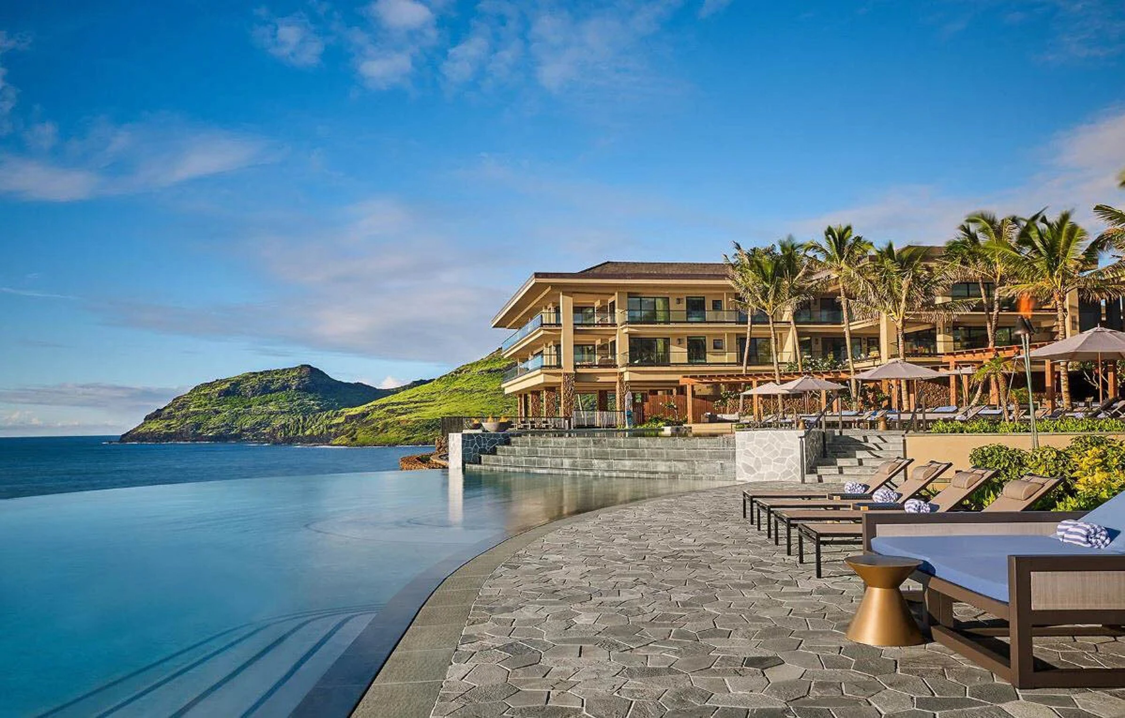 oceanfront resort with pool with mountains in the background