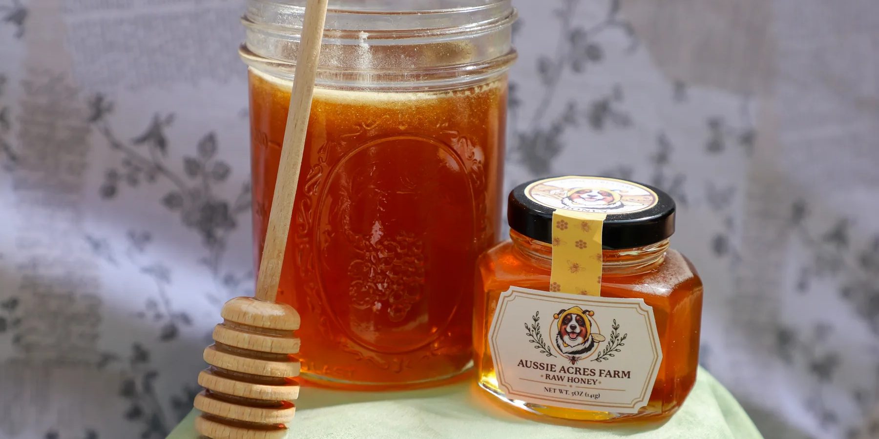 A jar of raw honey with a wooden honey dipper