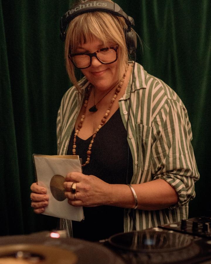 Rose Alice with 7-inch records in hand