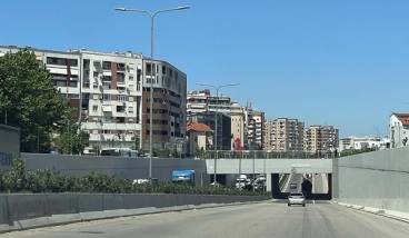 The Unaza e Madhe ring road underpass at Astir, with apartment blocks behind — Albinfo