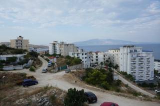 Apartment buildings above the bay at Sarandë, looking towards Corfu — Wilrooij