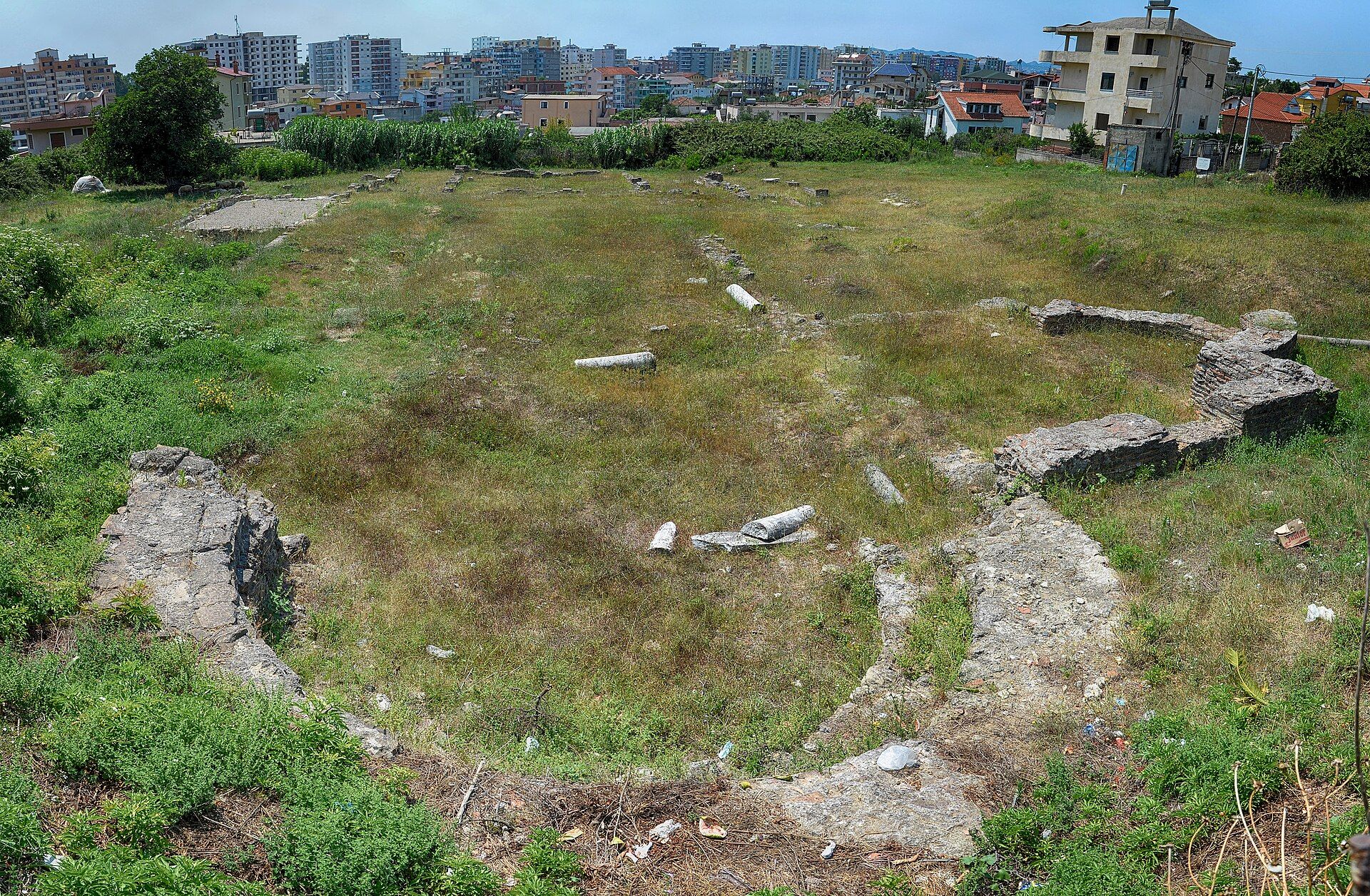 Ruins of the early Christian basilica of St Michael in Arapaj, with apartment blocks behind, Durrës — Pasztilla aka Attila Terbócs