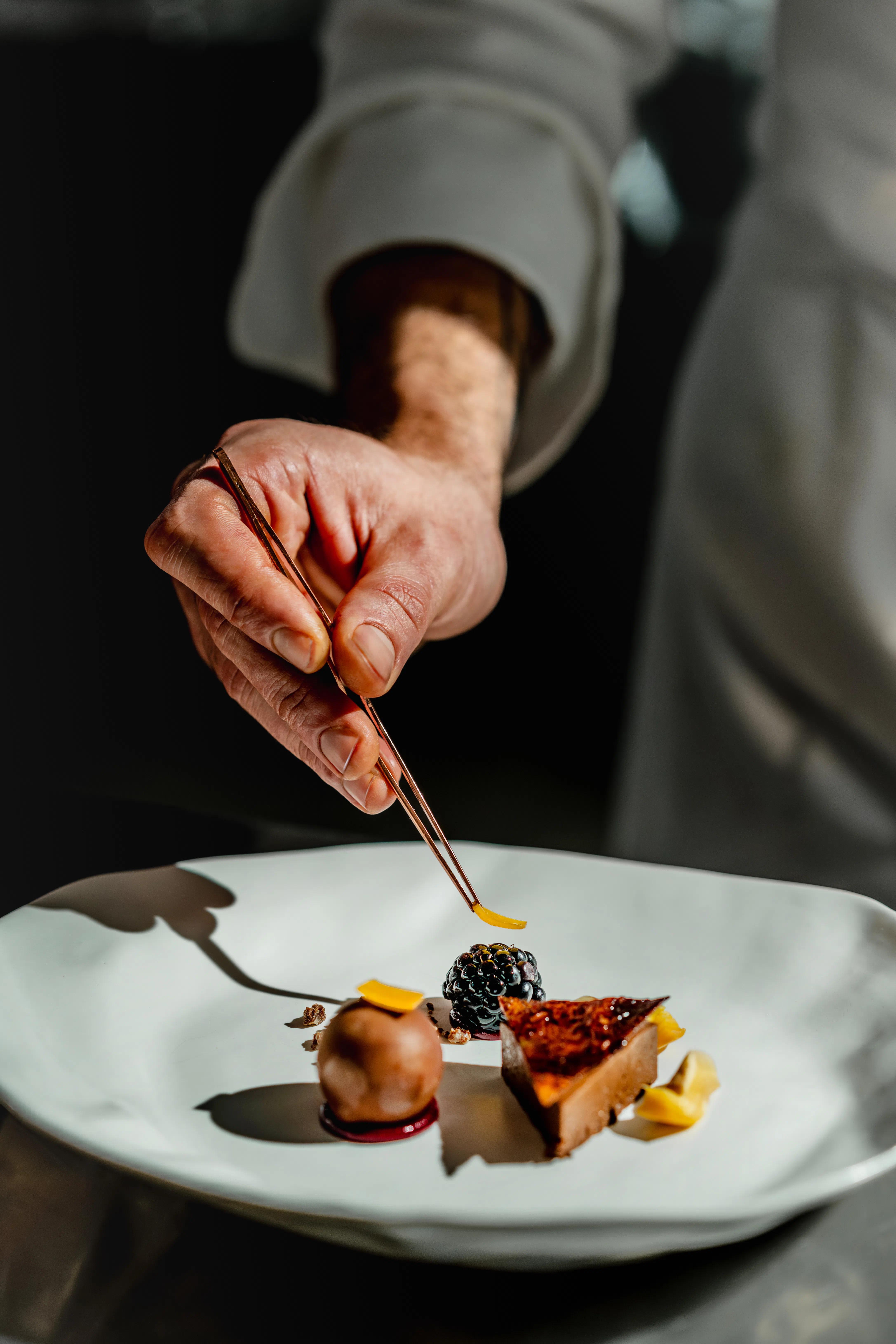 Lo Chef Simone Selva che termina la preparazione di una portata