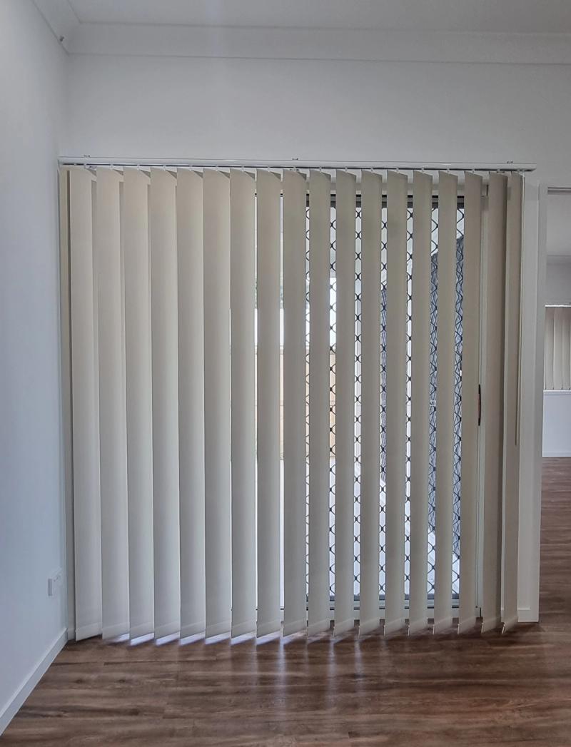 Vertical blinds close-up showing fabric blades and headrail detail