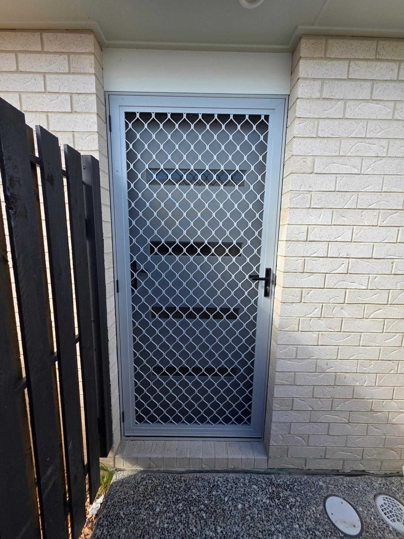 Traditional diamond grille barrier screen fitted to a hinge door