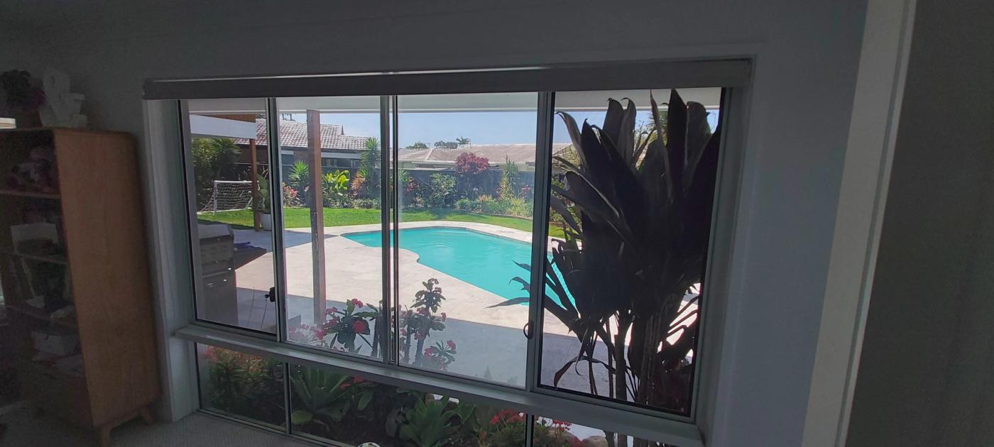 Fixed security screens on a bedroom sliding window